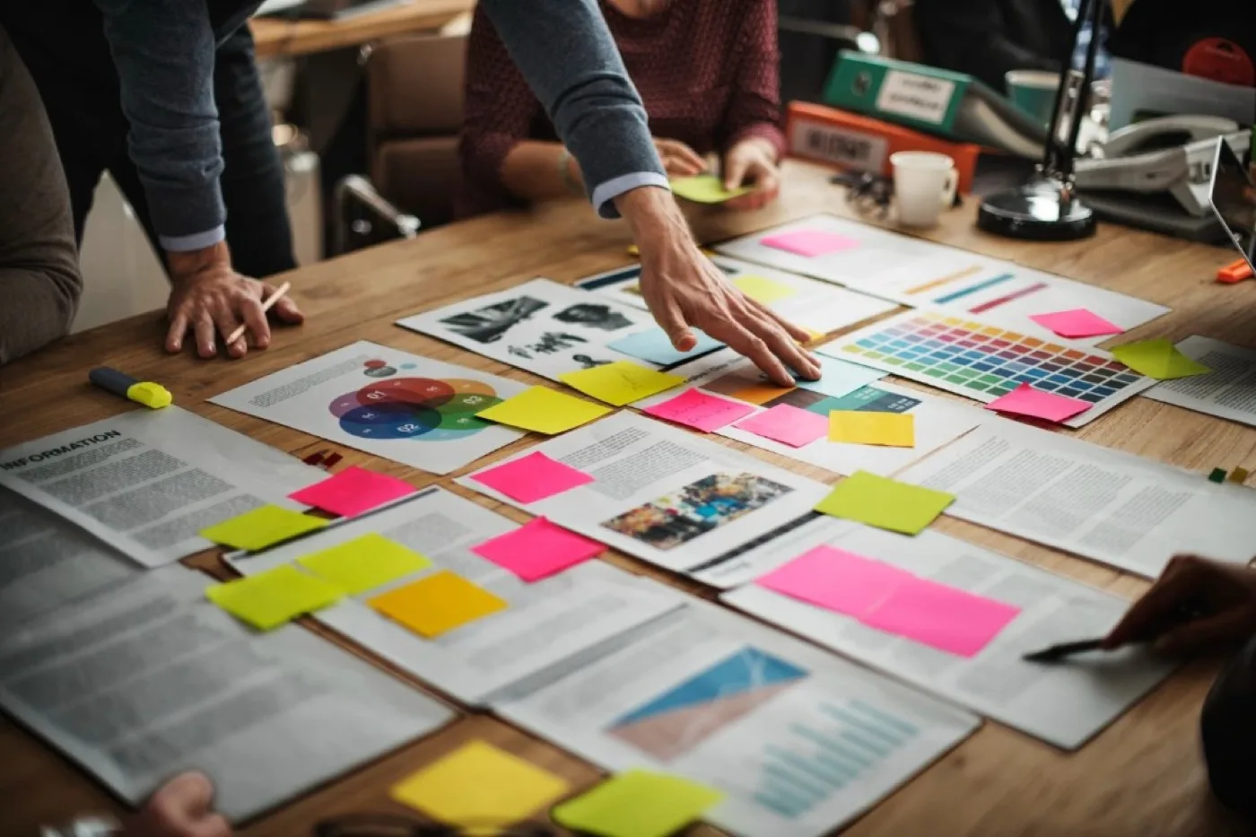 Team working together on a marketing strategy with diagrams and coloured sticky notes